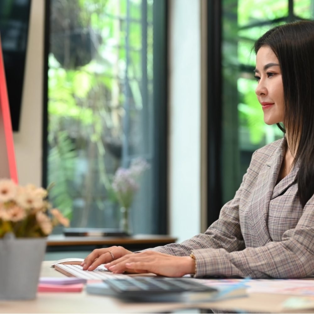 Filipino woman working in front of a computer